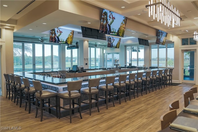 bar with light wood-type flooring and recessed lighting