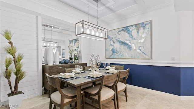 dining area featuring crown molding, an inviting chandelier, and light tile patterned floors