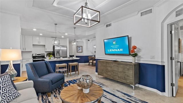 living room featuring crown molding, a chandelier, and light tile patterned flooring