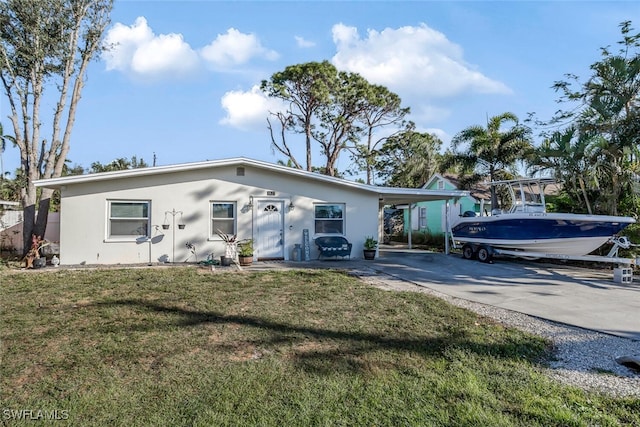 single story home with a carport and a front yard