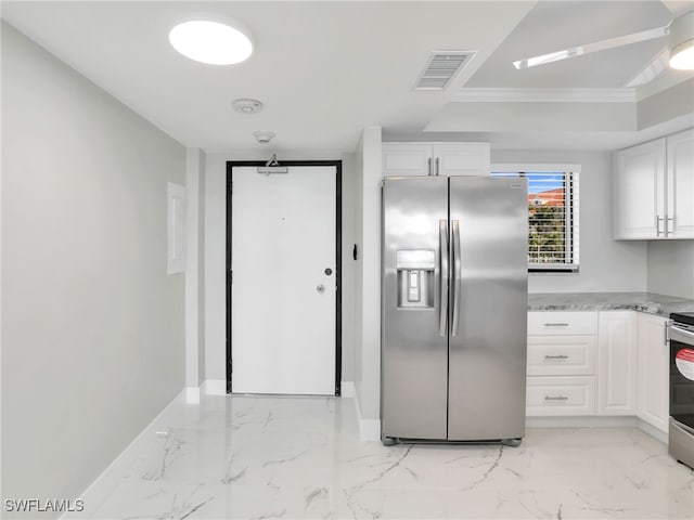 kitchen with white cabinets, crown molding, and stainless steel appliances