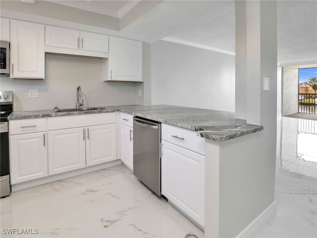 kitchen with kitchen peninsula, sink, appliances with stainless steel finishes, white cabinets, and crown molding