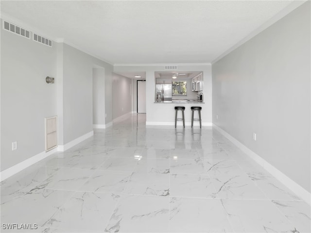 unfurnished living room with a textured ceiling and ornamental molding