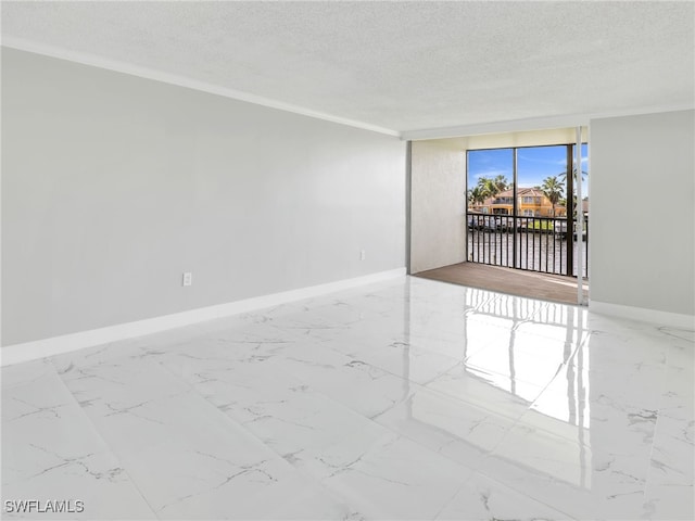 unfurnished room with ornamental molding and a textured ceiling