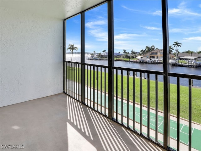 unfurnished sunroom with a water view