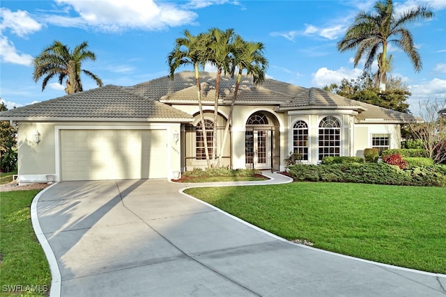 view of front of home featuring a garage, a front yard, and french doors