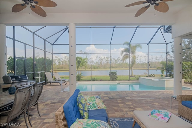 view of patio with a water view, ceiling fan, a swimming pool with hot tub, and a lanai