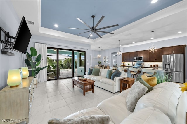 142 SW 35th Ave, Cape Coral, FL 33991 - living room with crown molding, a raised ceiling, and ceiling fan