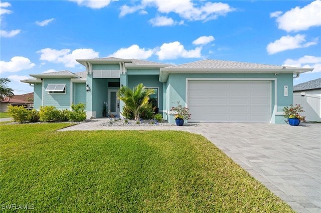 view of front of house with a garage and a front lawn