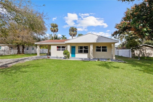 view of front of property with a carport and a front lawn