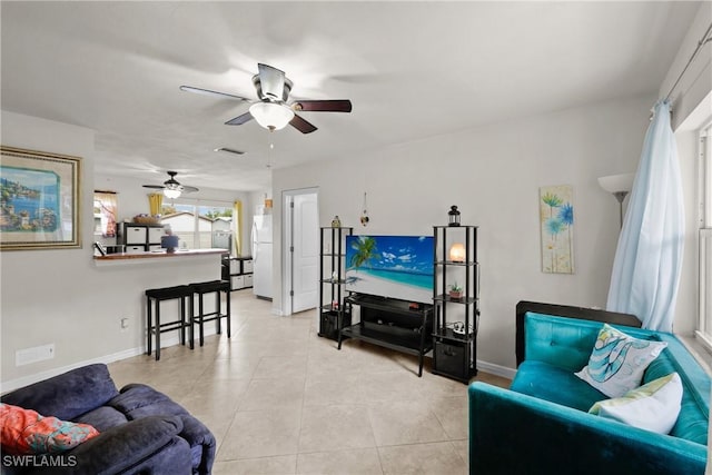 living room featuring ceiling fan and light tile patterned floors