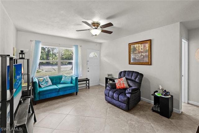 living area with ceiling fan and light tile patterned floors