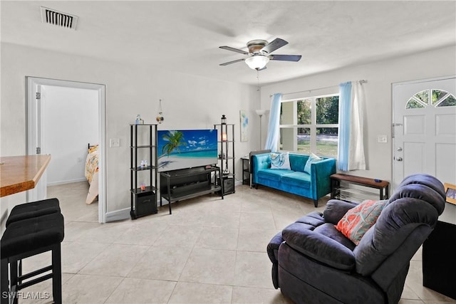 living room featuring ceiling fan and light tile patterned floors