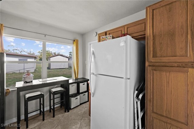 kitchen featuring white fridge and light tile patterned floors