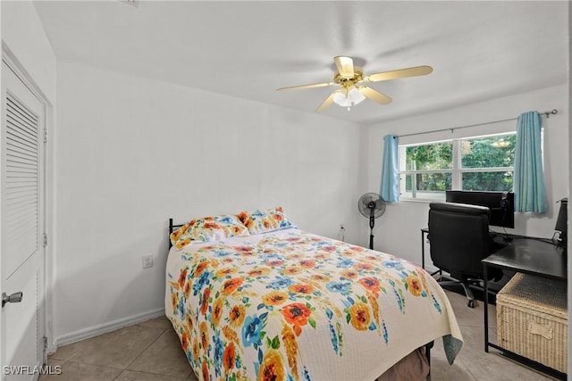 tiled bedroom featuring ceiling fan