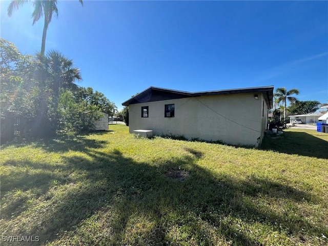 view of side of home featuring a lawn