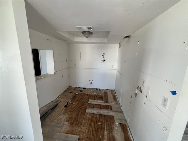 interior space featuring visible vents and a tray ceiling