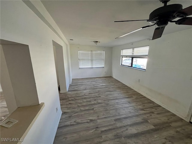 empty room featuring a ceiling fan and wood finished floors