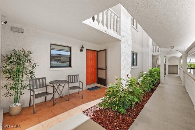 doorway to property featuring stucco siding