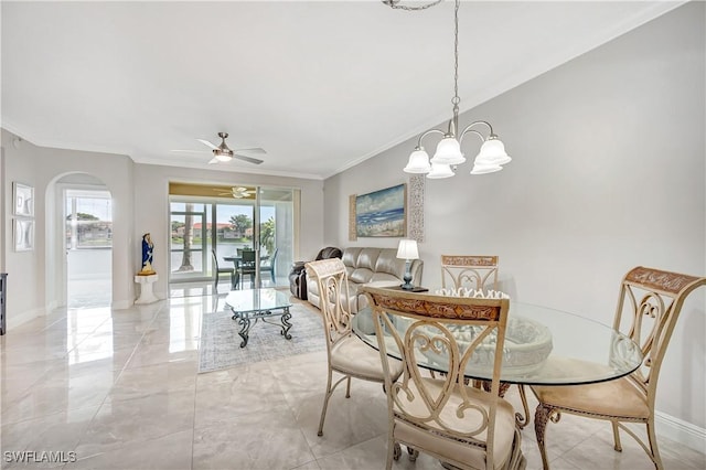 dining room featuring ornamental molding and ceiling fan with notable chandelier