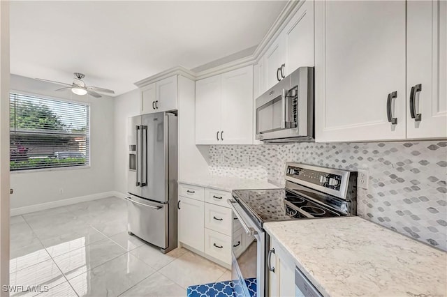 kitchen with appliances with stainless steel finishes, tasteful backsplash, white cabinetry, ceiling fan, and light stone counters