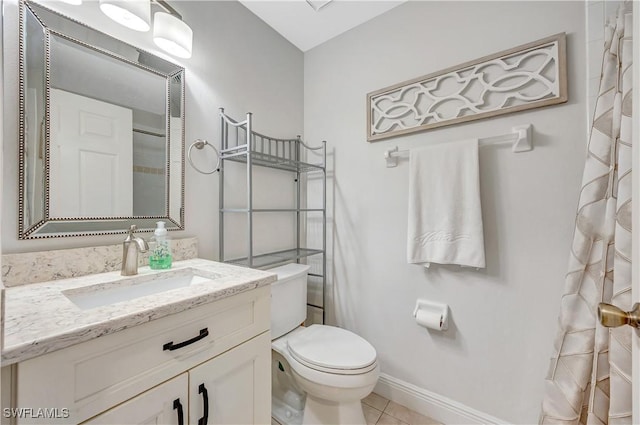 bathroom featuring vanity, tile patterned floors, and toilet