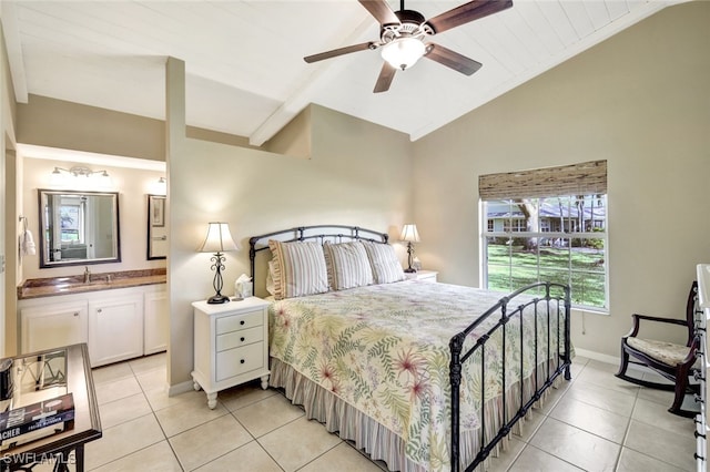 14899 Crescent Cove Dr, Fort Myers, FL 33908 - bedroom with light tile patterned floors, vaulted ceiling, a sink, baseboards, and ensuite bathroom