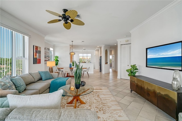 living room with ornamental molding, light tile patterned floors, and ceiling fan