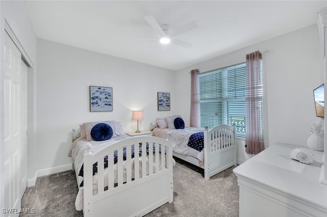 carpeted bedroom with ceiling fan and a closet