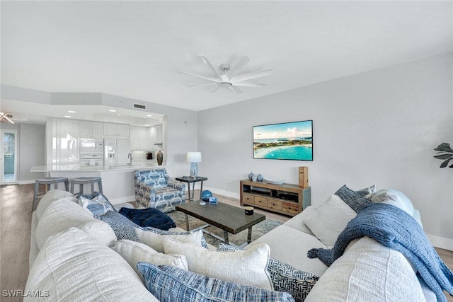 living room with hardwood / wood-style floors and ceiling fan