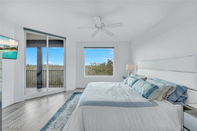 bedroom with access to exterior, floor to ceiling windows, ceiling fan, and light wood-type flooring