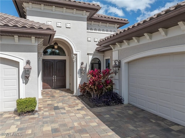 view of exterior entry with a garage