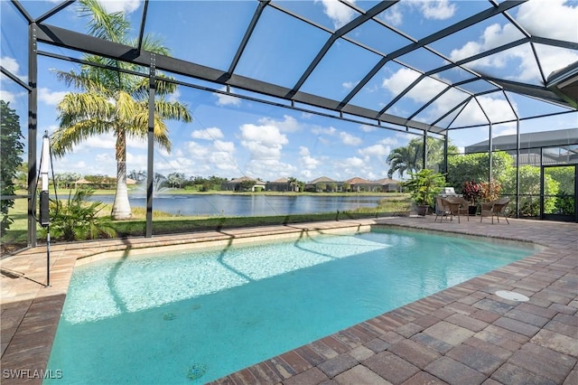 view of swimming pool featuring a patio, a water view, and glass enclosure