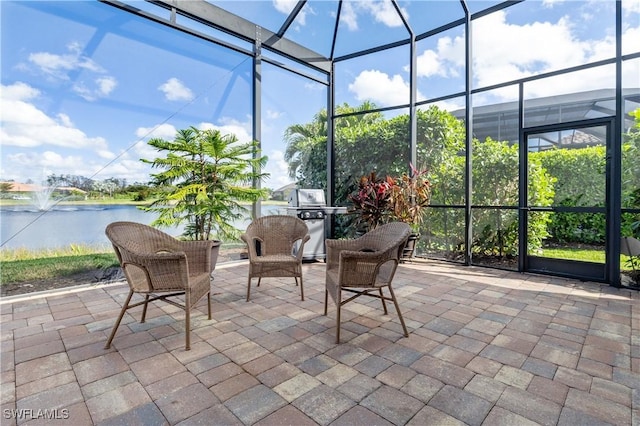 sunroom / solarium featuring a water view