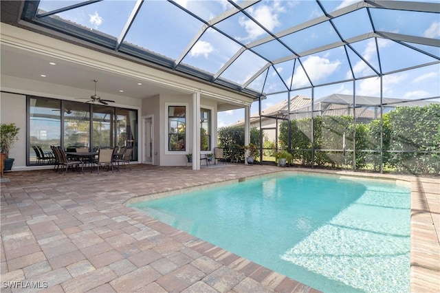 view of pool with a lanai, a patio, and ceiling fan