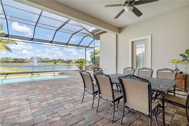 view of patio / terrace with a water view and a lanai