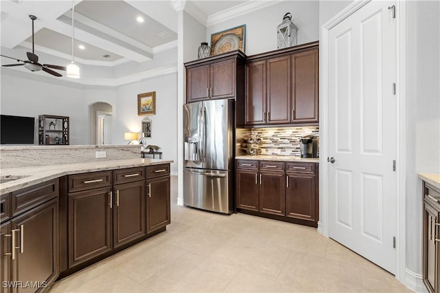 kitchen featuring stainless steel refrigerator with ice dispenser, dark brown cabinetry, coffered ceiling, light stone countertops, and decorative backsplash