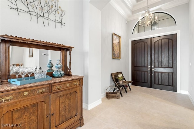 tiled foyer featuring an inviting chandelier, a towering ceiling, indoor bar, and crown molding