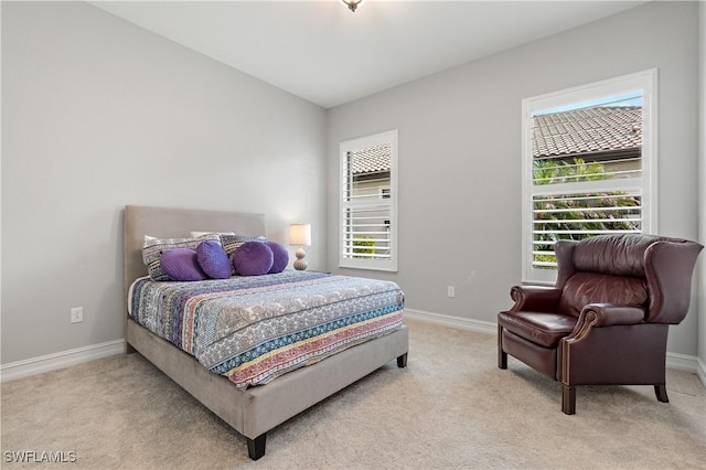 bedroom featuring light carpet and vaulted ceiling