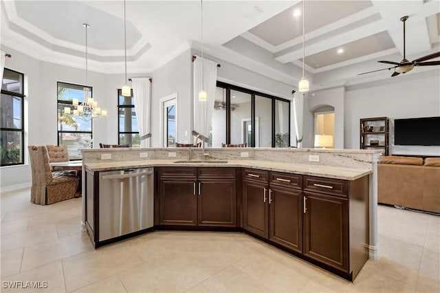 kitchen featuring pendant lighting, sink, a kitchen island with sink, and dishwasher