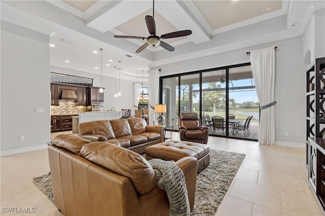 tiled living room featuring beam ceiling, a healthy amount of sunlight, and ceiling fan