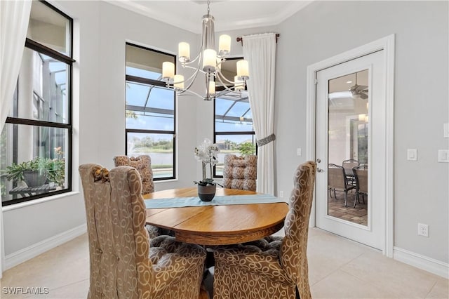 tiled dining area featuring crown molding and a chandelier