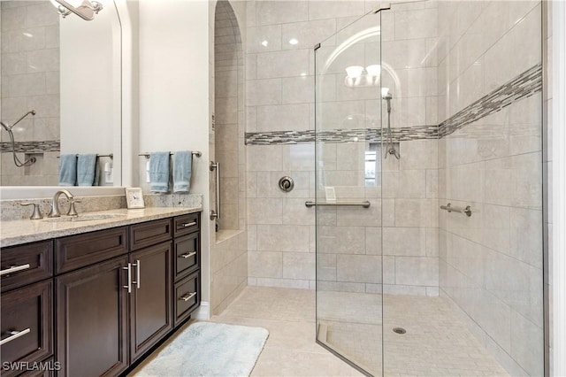 bathroom featuring vanity and tiled shower