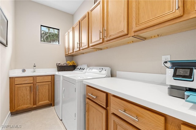 washroom featuring sink, cabinets, and washing machine and clothes dryer