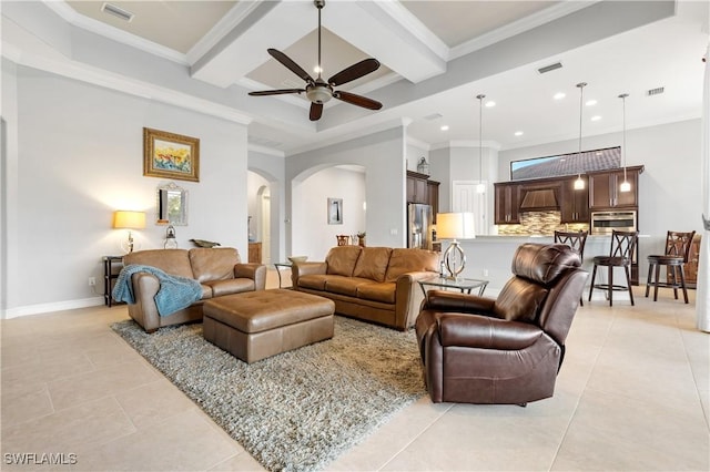 living room featuring a high ceiling, ornamental molding, and light tile patterned floors