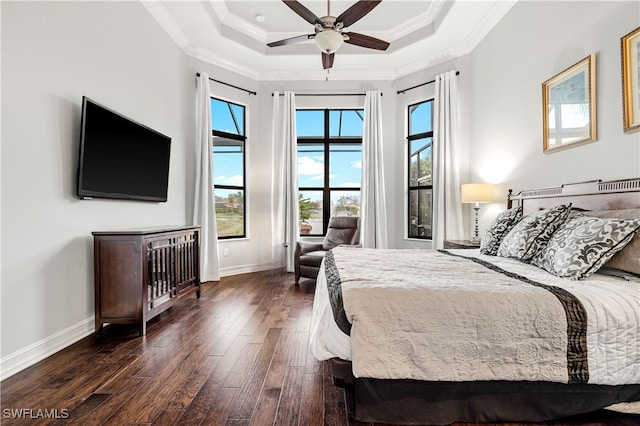 bedroom featuring crown molding, ceiling fan, a tray ceiling, and dark hardwood / wood-style flooring