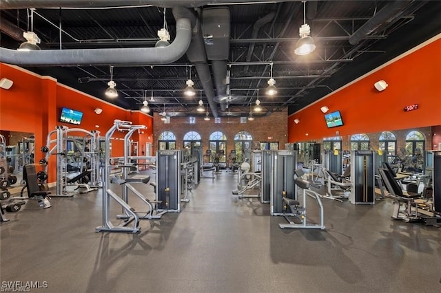 gym featuring a towering ceiling