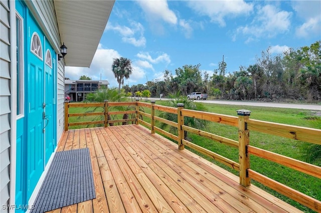 wooden deck featuring a yard