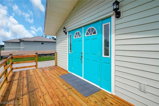 property entrance with a wooden deck