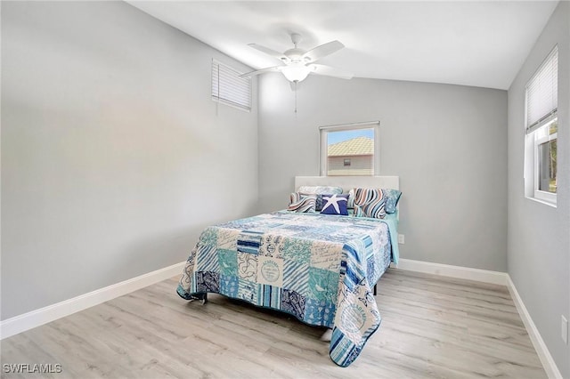 bedroom with vaulted ceiling, ceiling fan, and light hardwood / wood-style flooring